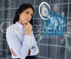 Woman standing thinking looking at world map hologram