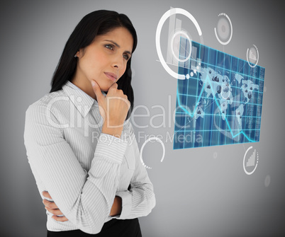 Business woman looking at world map hologram