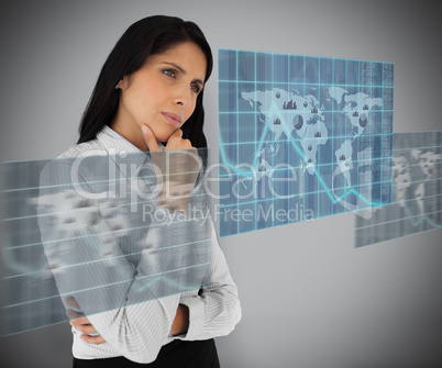 Woman standing thinking against grey background