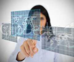 Woman selecting world map image from hologram interface