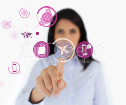 Woman selecting airplane symbol from purple interface