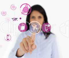 Woman selecting airplane symbol from purple interface