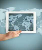 Hand holding a tablet PC showing business world map graphic