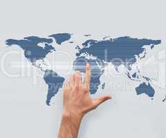 Hand pointing on world map