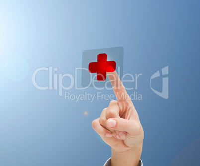 Womans hand pointing to hospital symbol