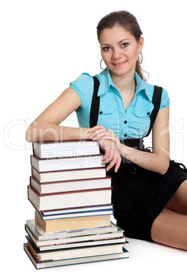 Beautiful student is holding a lot of books