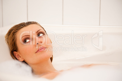 Woman is relaxing in a bathtub