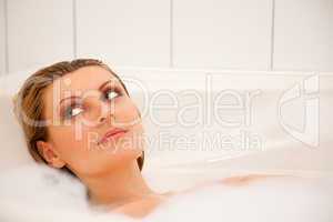 Woman is relaxing in a bathtub