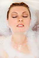 Woman is relaxing in a bathtub