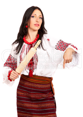 Angry housewife with rolling pin. Woman wears Ukrainian national