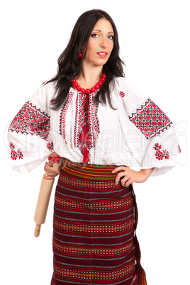 Angry housewife with rolling pin. Woman wears Ukrainian national