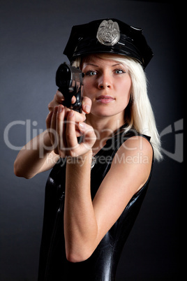 Beautiful sexy police girl with handgun and handcuffs