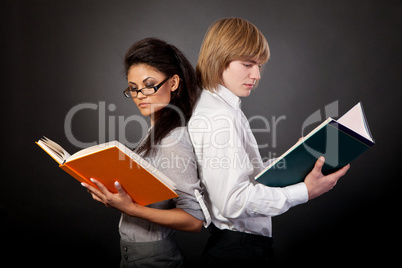 Two students are reading books