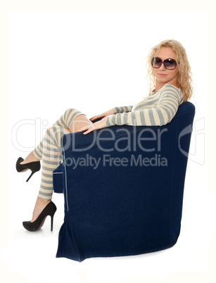 Young woman sitting in a navy armchair