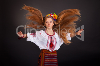 Portrait of a beautiful girl with flying brown hair. Woman wears