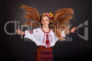 Portrait of a beautiful girl with flying brown hair. Woman wears