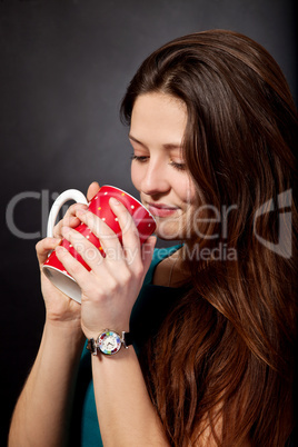Beautiful young girl is holding a red cup