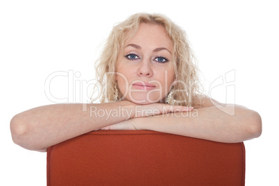 Young woman sitting in a red armchair