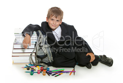 Boy, pencils, paints and books