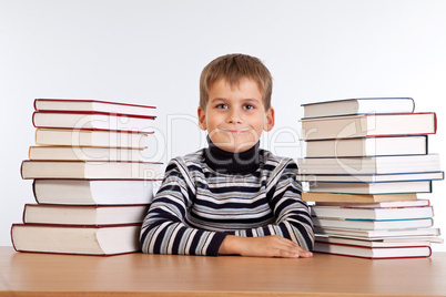 Schoolboy and a heap of books