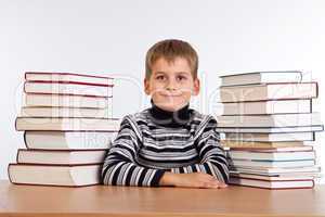 Schoolboy and a heap of books