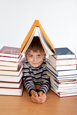 Schoolboy and a heap of books