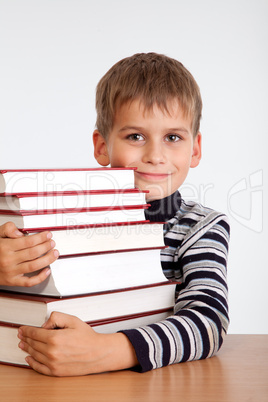 Schoolboy and a heap of books