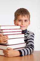 Schoolboy and a heap of books