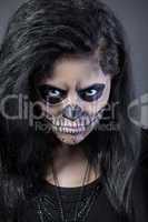 Young woman in day of the dead mask skull. Halloween face art