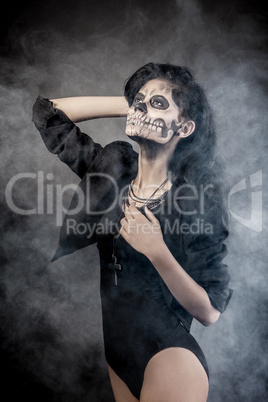 Young woman in day of the dead mask skull. Halloween face art