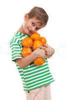 Boy holding oranges