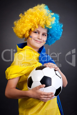 Football fan with  ukrainian flag on a black background