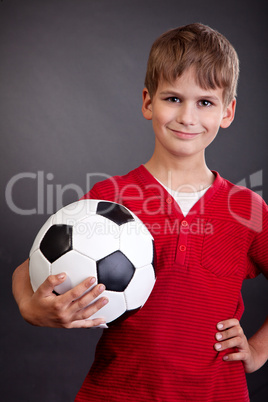 Cute boy is holding a football ball. Soccer ball