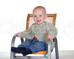 Happy smiling baby in a highchair