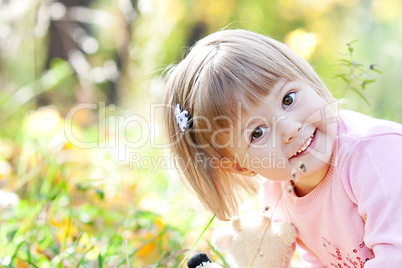 portrait of a beautiful little girl in the autumn forest