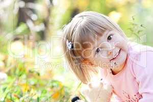portrait of a beautiful little girl in the autumn forest