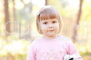 portrait of a beautiful little girl in the autumn forest