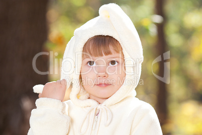 beautiful little girl in costume bunny in the autumn forest