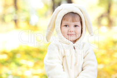 beautiful little girl in costume bunny in the autumn forest