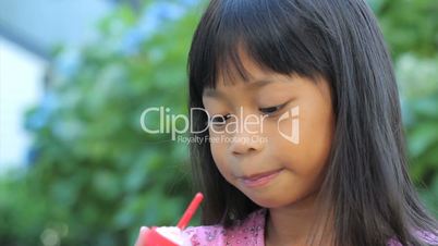 Smiling Asian Girl Enjoys A Popsicle-Close Up