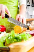 Woman's hands cutting vegetables