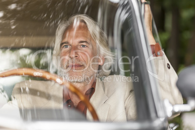 man in his car