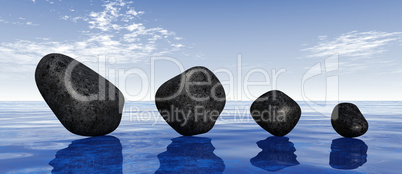 Black stones on blue water
