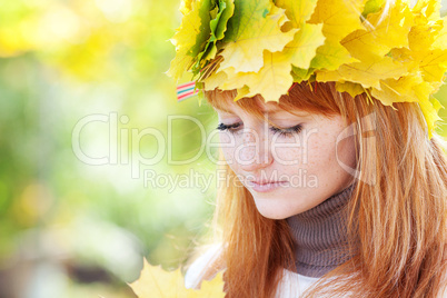 portrait of a beautiful young redhead teenager woman in a wreath