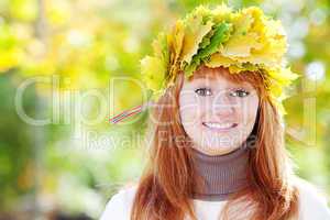 portrait of a beautiful young redhead teenager woman in a wreath