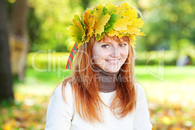 portrait of a beautiful young redhead teenager woman in a wreath