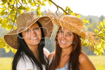 Mother and teen daughter relaxing outdoors happy