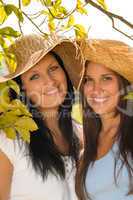 Mother and teen daughter relaxing outdoors happy