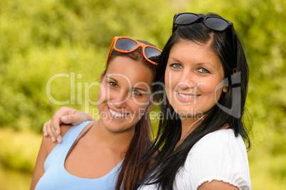 Mother and daughter smiling in the park