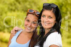 Mother and daughter smiling in the park